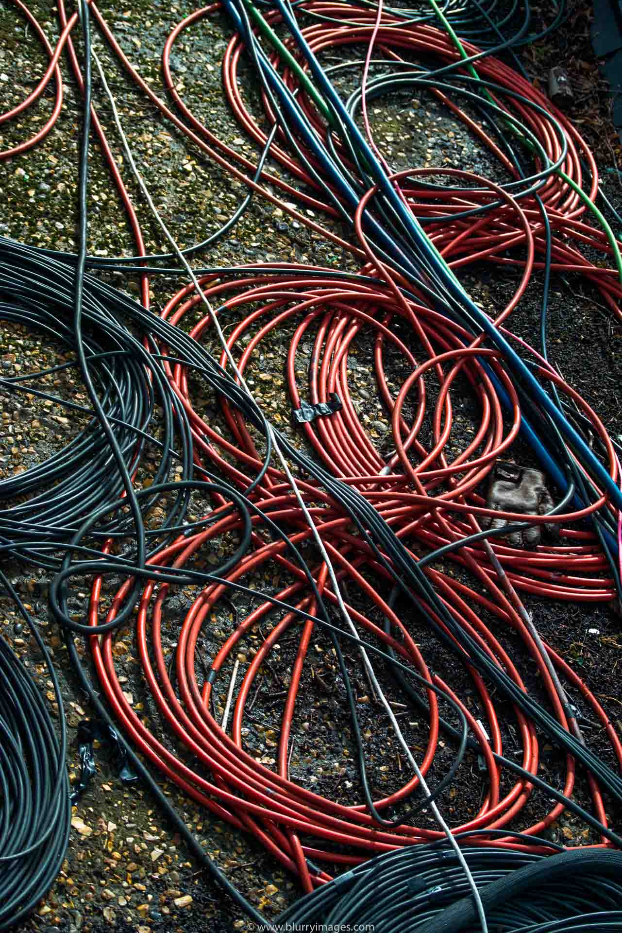 Powers cable, rolled up, red, green, plain background, electricity, no people, colour image, ideas, border, energy efficient, horizontal photography, red cables, blue cables, outdoors,