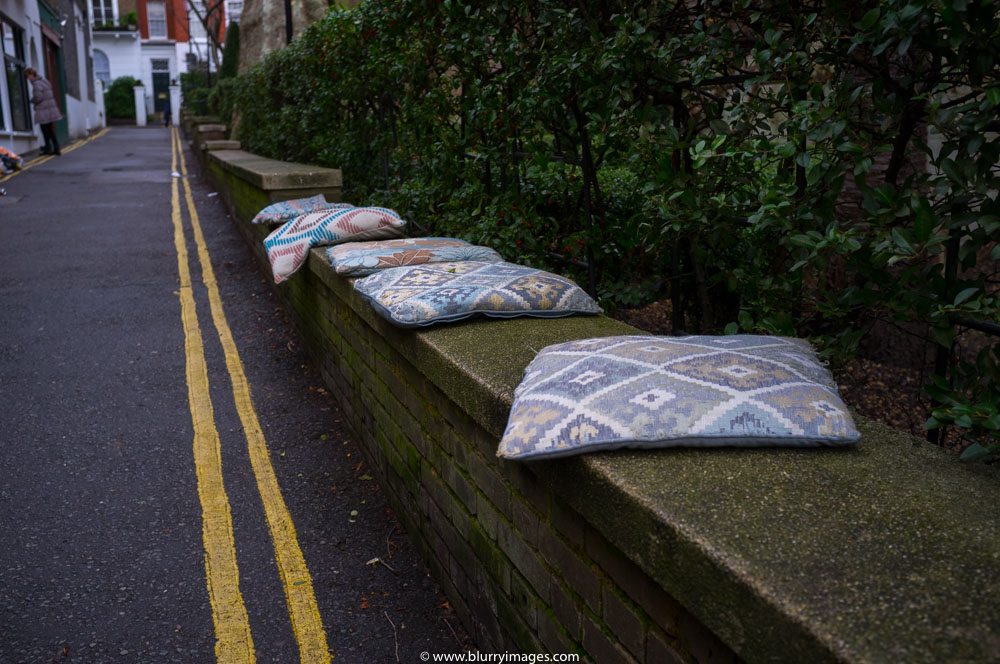 colourful pillows, four pillows, pillows on the conrecete wall, street photography