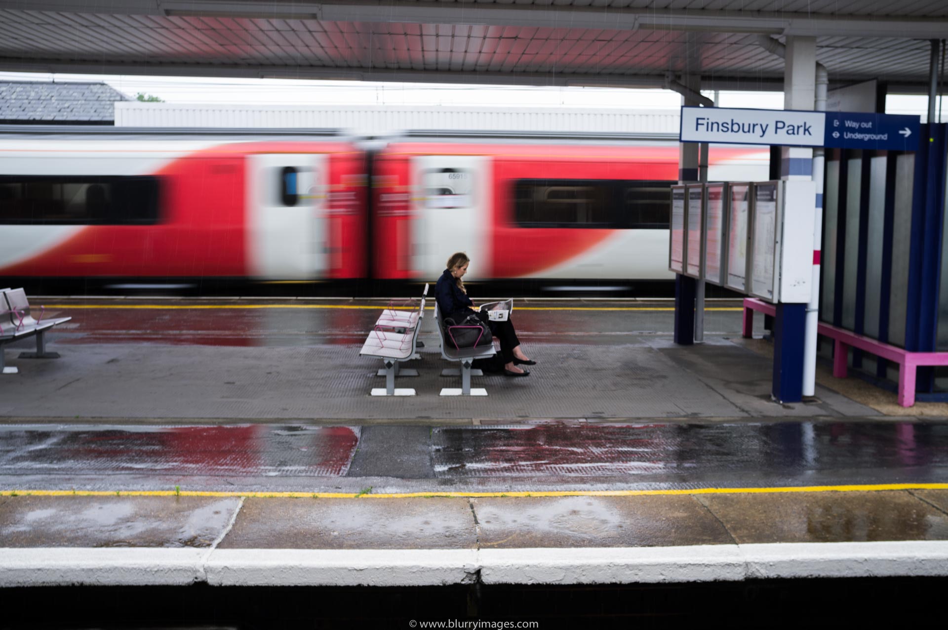 Brexit in UK, woman reading newspaper, train station, train