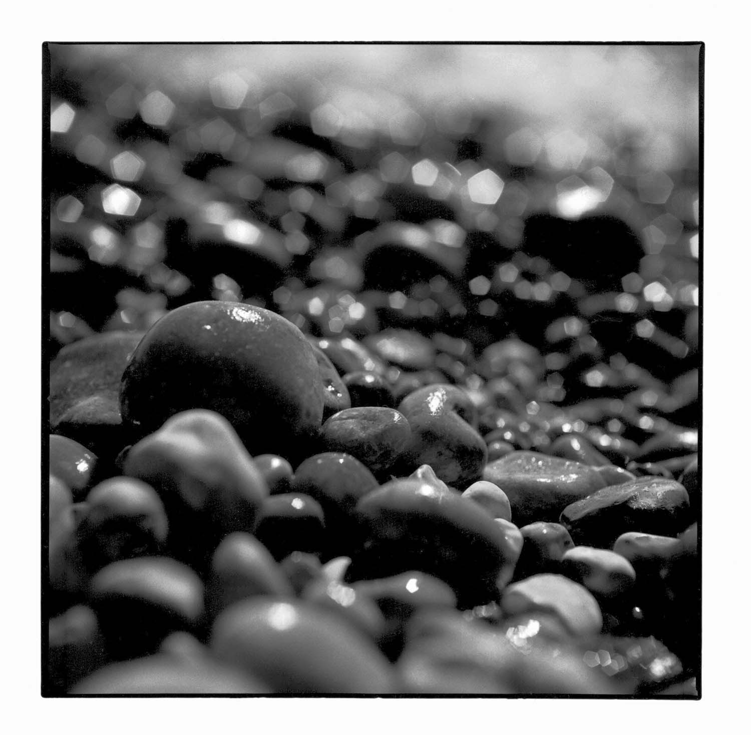 The darkroom gallery - wet stones on a beach in Bournemouth, UK.