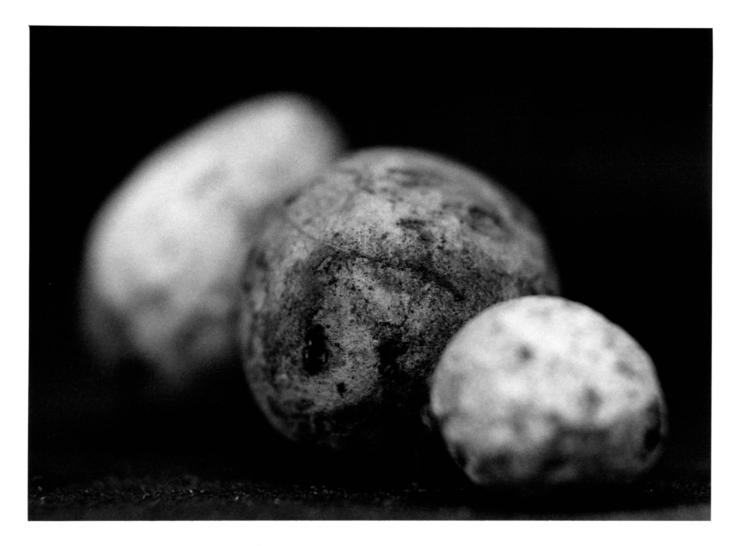 A black and white abstract photograph of a three stones.